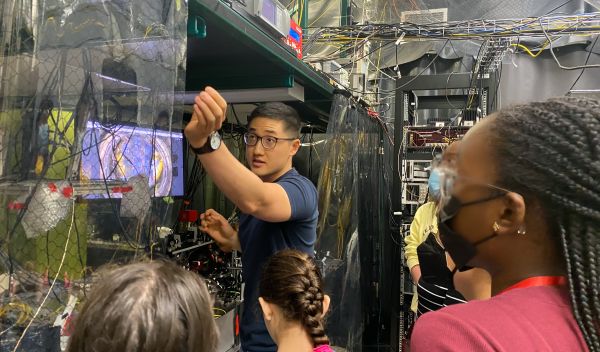 High school students in the University of Maryland's Advanced Physics Summer Girls' Camp view an ion trap