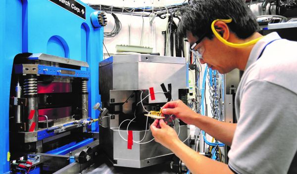 Beamline scientist Tony Yu preparing an acoustic emission experiment for the 1000-ton multi-anvil press in the GSECARS 13-ID-D station.