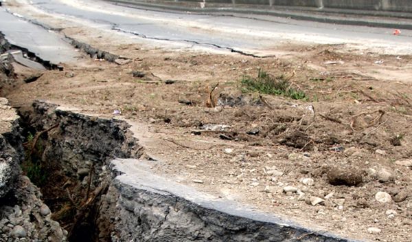 A fissure, caused by an earthquake, across a roadway.