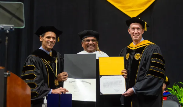SF Director Sethuraman Panchanathan (center) receives an honorary degree from VCU President Michael Rao, Ph.D., (left) and Todd Haymore, rector of the VCU Board of Visitors (right).