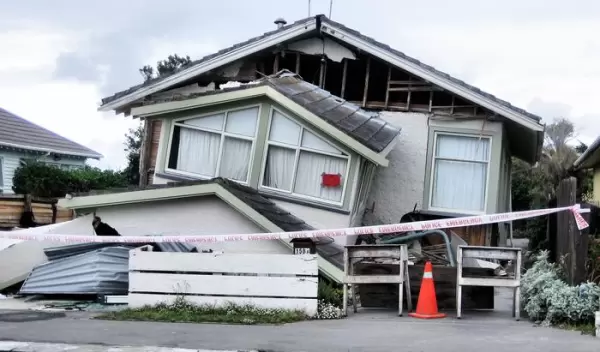 A house in Christchurch, New Zealand, following an earthquake in February 2011. Researchers are working to isolate tremors that could be used to warn of a major earthquake.