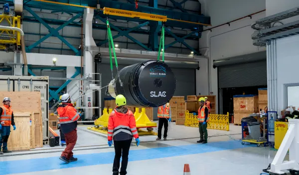 The Legacy Survey of Space and Time Camera is hoisted out of its custom-built container by staff at the NSF-DOE Vera C. Rubin Observatory on the summit of Cerro Pachón in Chile.