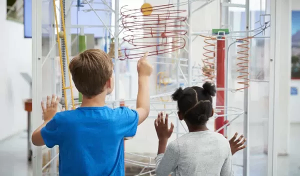 two young students learning in a science environment