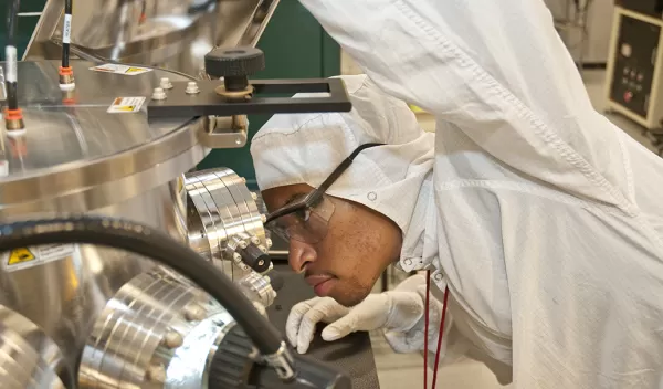 male scientist looking at equipment