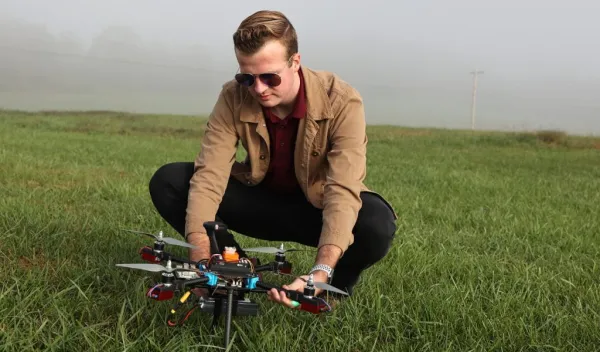Garrett Asper prepares a multi-rotor drone for a series of test flights