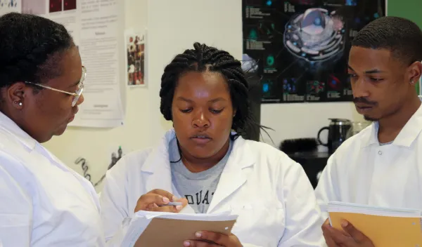 Students and faculty in a science lab.