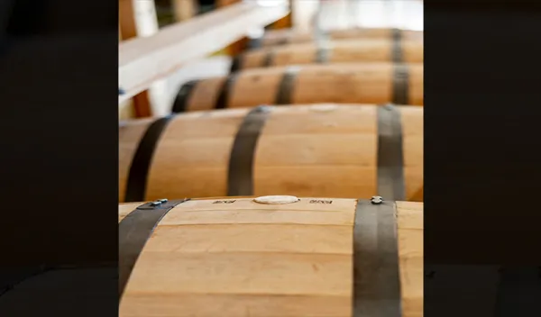 A row of whiskey barrels made of white oak