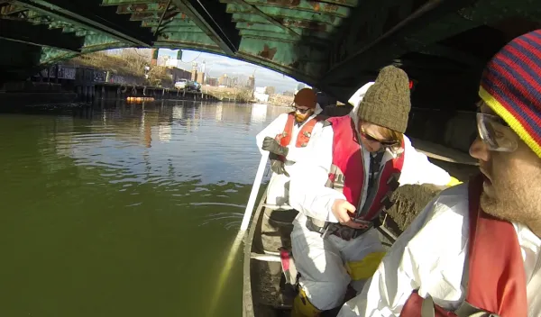 A research team takes a boat down Brooklyn's Gowanus Canal to take samples.
