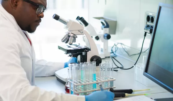 African-american man working in lab. Scientist doctor making medical research.