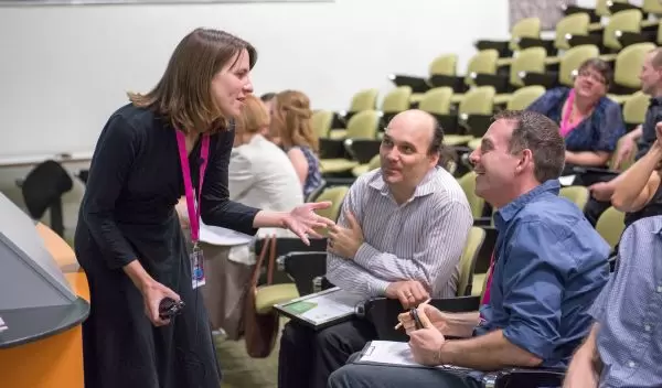Michelle Smith talking with people in a lecture hall