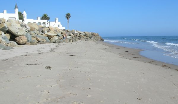 Large rock revetment in the intertidal zone of a sandy beach in Santa Barbara County, California.