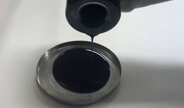 liquid asphalt rubber binder poured in a dish