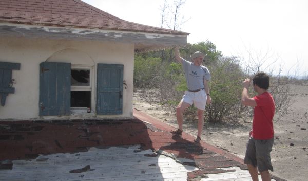 E. Bruce Pitman and colleague next to a house damaged by mudslides in Montserrat