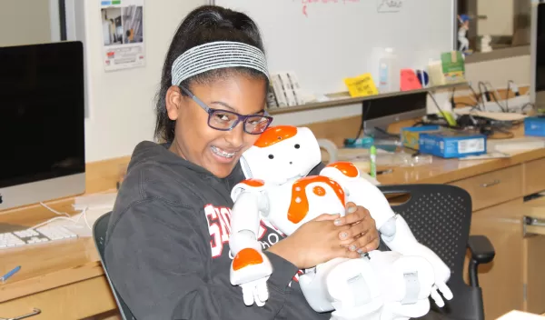Girl holds robot
