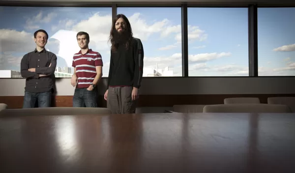 gradute students , Francois Hebert, Andy Bohn and William Throwe standing in a classroom