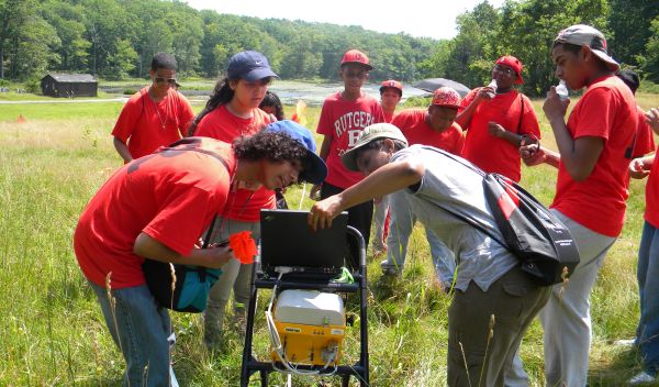 Rutgers-Newark graduate students with high-school student and a ground-penetrating radar