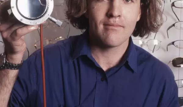 Photo of Saul Griffith with his eyeglass lens 'printer.'