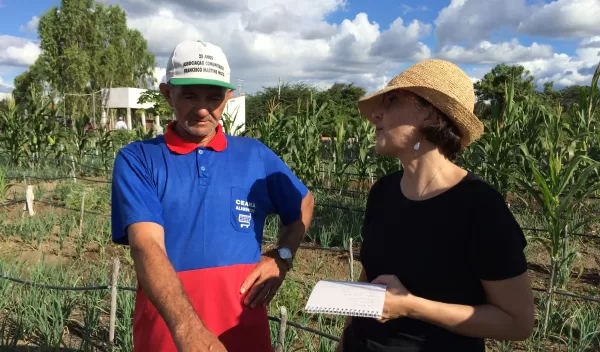 Maria Carmen Lemos talking to a local man