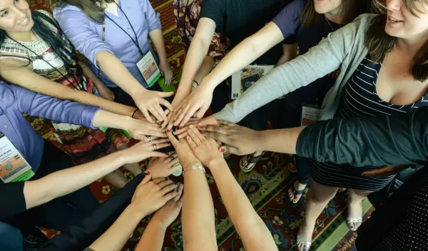 women with their hands together