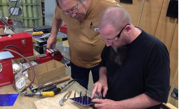 Instructor working with a student at a technology center