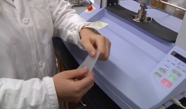 researcher holding a piece of plastic