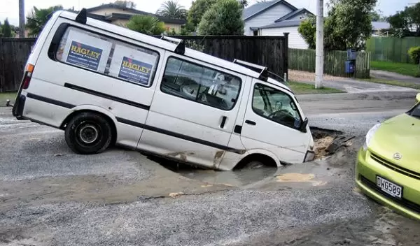 Sink holes and liquefaction on roads in Christchurch, New Zealand.