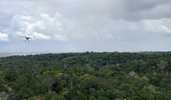 a drone flies toward a rainstorm in the Amazon