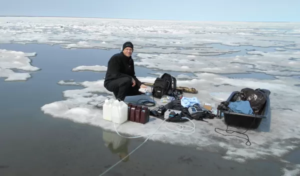 researcher James McClelland sampling water