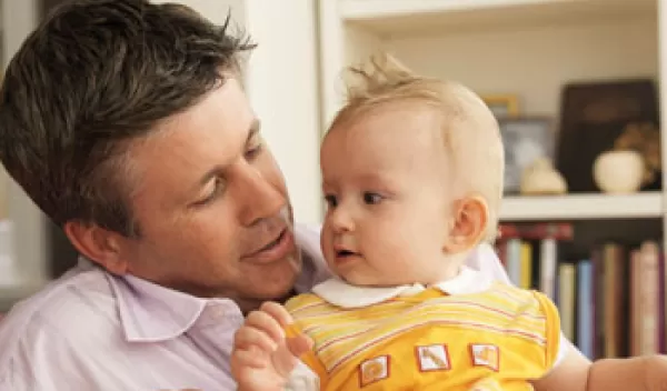 Photo of a father holding a baby.