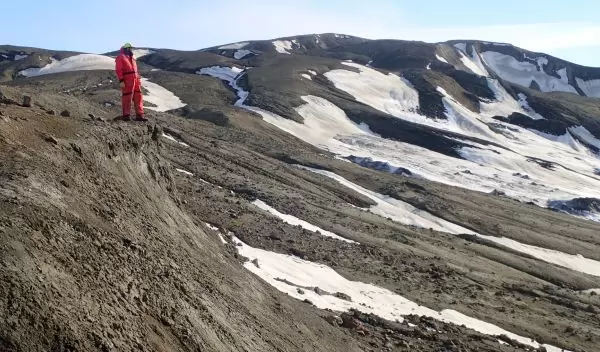 a Northwestern University researcher stands on the Lopez de Bertodano Formation
