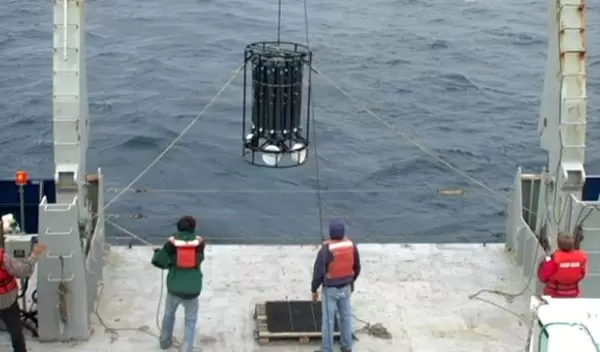 University of Hawaii researchers use taglines to control sway of sampling device entering water.