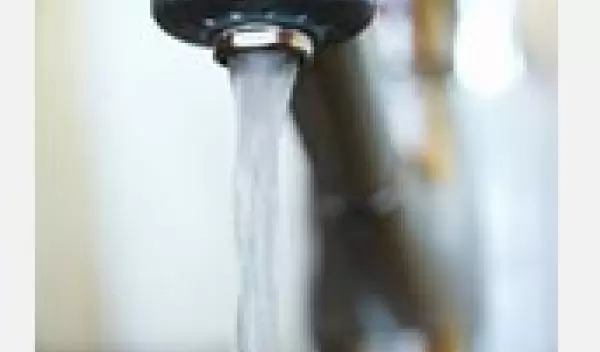 Photo of water coming out of a faucet.