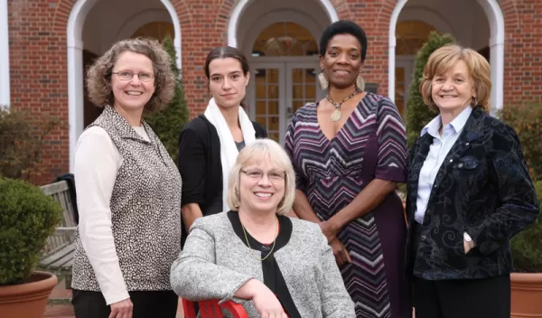 Teachers in front of a building