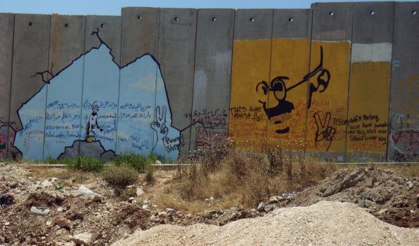 A drawing of Mahatma Gandhi on the wall separating the West Bank from Israel.
