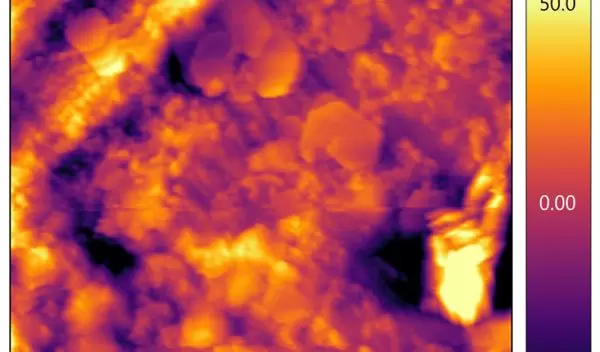 Iron corroding and degrading into thin layers of calcium carbonate and iron carbonate.