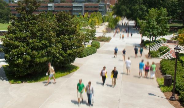 people walking on a sidewalk