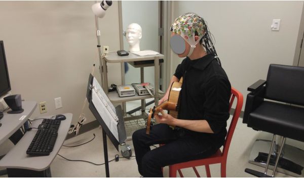 jazz guitar player improvising while brain activity is recorded