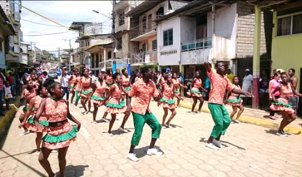 group of people dancing down a street
