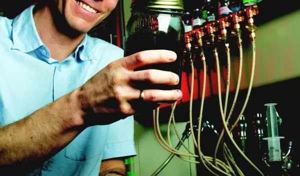 Photo of Daniel Bond holding Geobacter microbes.