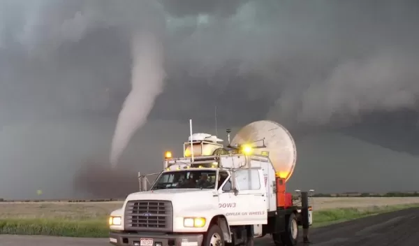 Photo of a tornado on the horizon and the DOW in the foreground.