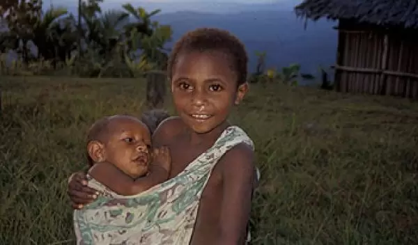 Older child carrying an infant