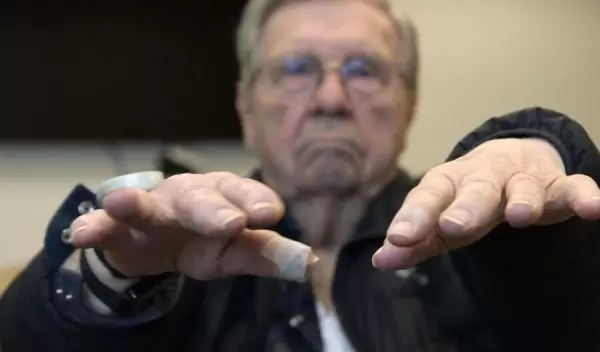 research study participant testing his hands for tremors