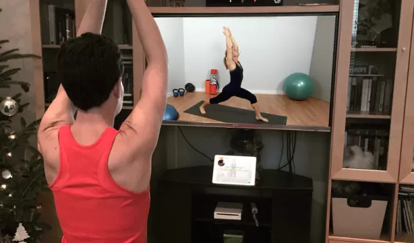 woman exercising in front of monitor