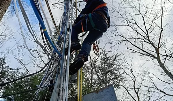 Scientist Daniel Obrist climbs a tower in Harvard Forest to measure mercury deposition.
