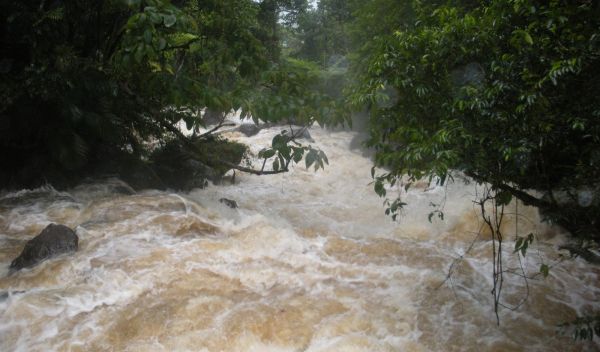 Photo showing a raging torrent of water overflowing its banks in Puerto Rico.