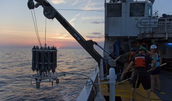 Researchers recover a CTD instrument used to collect water samples from multiple depths in the ocean.