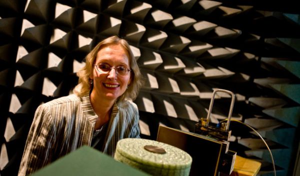Photo of Elena Semouchkina testing a microwave dielectric cloak in an anechoic chamber.