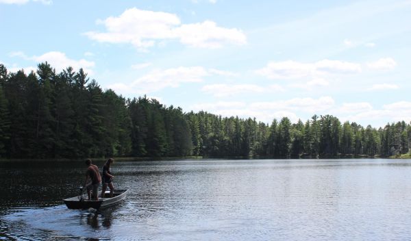 Colin Dassow and researcher Mary Solokas on Camp Lake
