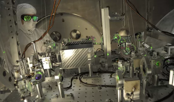 NSF LIGO specialist checks the alignment of a test beam