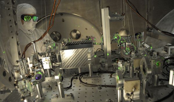NSF LIGO specialist checks the alignment of a test beam
